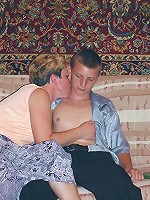 Horny mature babe joins a cute guy in the living room to dish out her eager muff