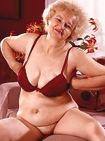 Grey haired mature model strips off to play with her sagged boobs and experienced snatch live