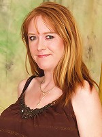 This red mature slut gets wet on herself