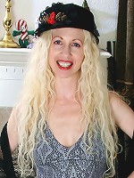 Long haired blonde MILF spreads in her knee high striped socks