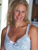 Busty blonde housewife Cally Jo fingers her pussy on the sof...