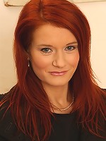 Seductive mature redhead Lucy Red posing naked in heels.