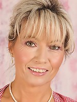 Country cougar Janet Darling tickles her own g-spot.