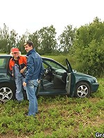 Granny shows her tits then gets in the car for a ride to the country where they double team her